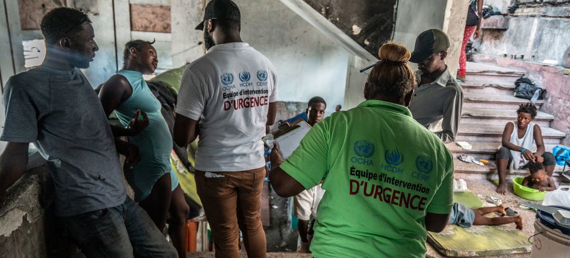 Workers from a local UN NGO partner, UCCEDH, assess the needs of displaced people in downtown Port-au-Prince.