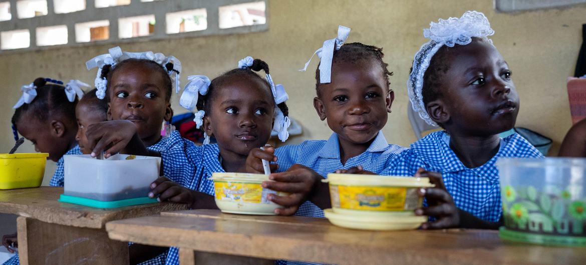 Children in Haiti eat a hot meal provided by the UN and partners at school. Children in Haiti eat a hot meal provided by the UN and partners at school.