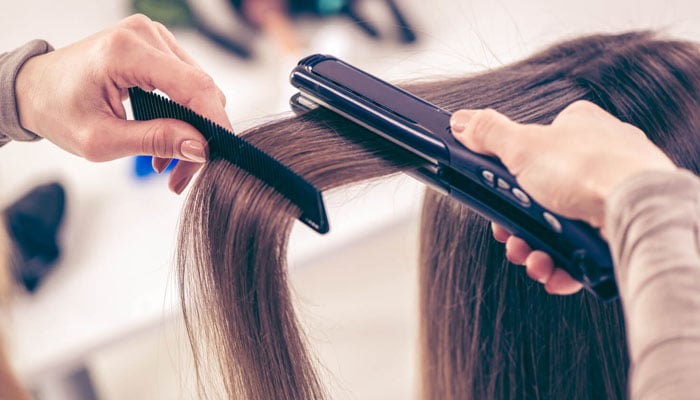 How to use 'straightener' to straighten hair? File photo
