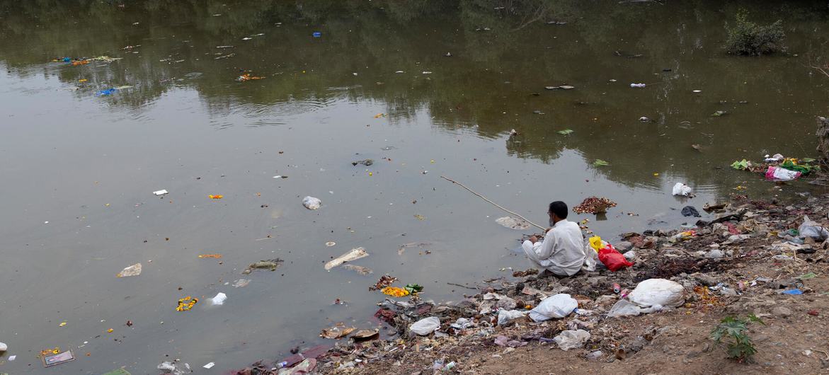 A man fishes on the banks of the Mithi River in western India that has become an open dump for sludge oil and hazardous chemicals. A man fishes on the banks of the Mithi River in western India that has become an open dump for sludge oil and hazardous chemicals.