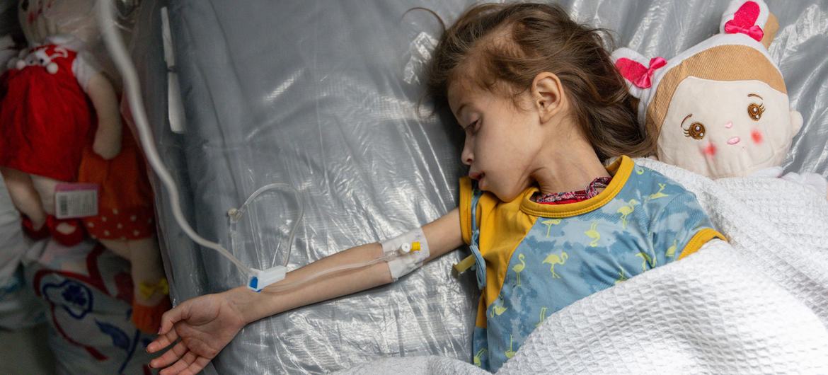 A child with severe acute malnutrition and dehydration is treated at a field hospital in southern Gaza in April 2024.