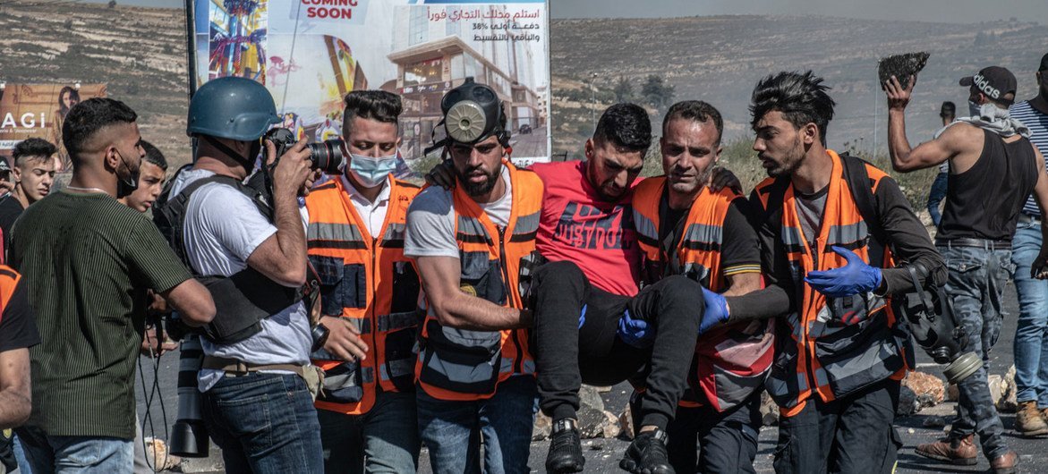 An injured man is helped by rescue workers in Ramallah, in the West Bank, in May 2021. (file) An injured man is helped by rescue workers in Ramallah, in the West Bank, in May 2021. (file)