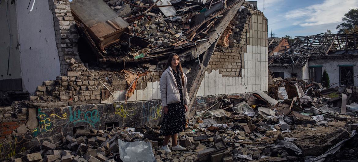 A Ukrainian teenager stands in the rubble of her destroyed school in Zhytomyr (file).